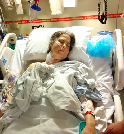 Donna Hart lying in a hospital bed