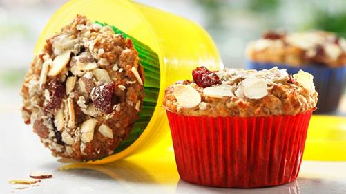Muesli muffins with almonds and cranberries on kitchen counter 